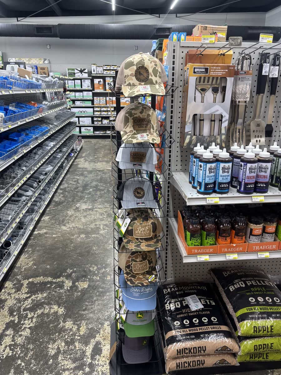 Cardinal Hardware branded camo and red hats on the display rack