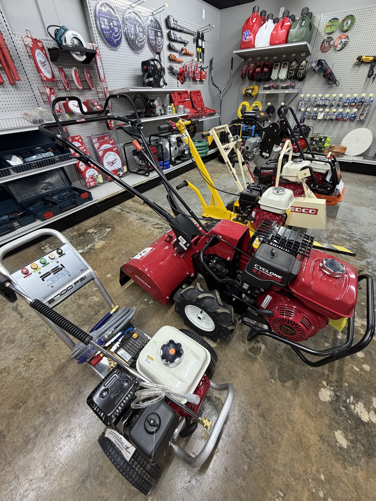 Rental room at Cardinal Hardware — tillers, pressure washer, and plate compactor ready to rent
