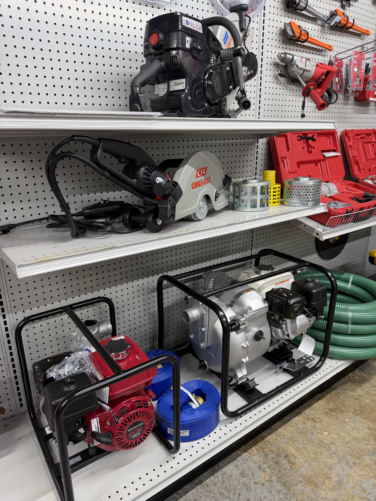 Walk-behind cut-off saw and water transfer pumps in the rental room at Cardinal Hardware