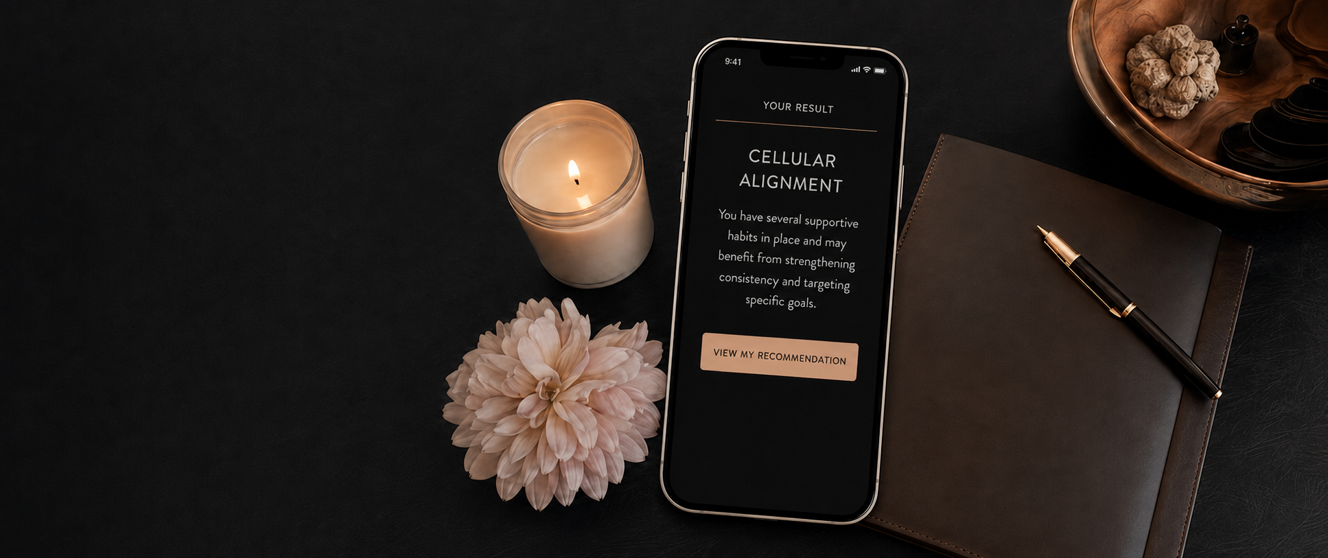 Phone showing Cellular Alignment assessment result next to a candle and journal