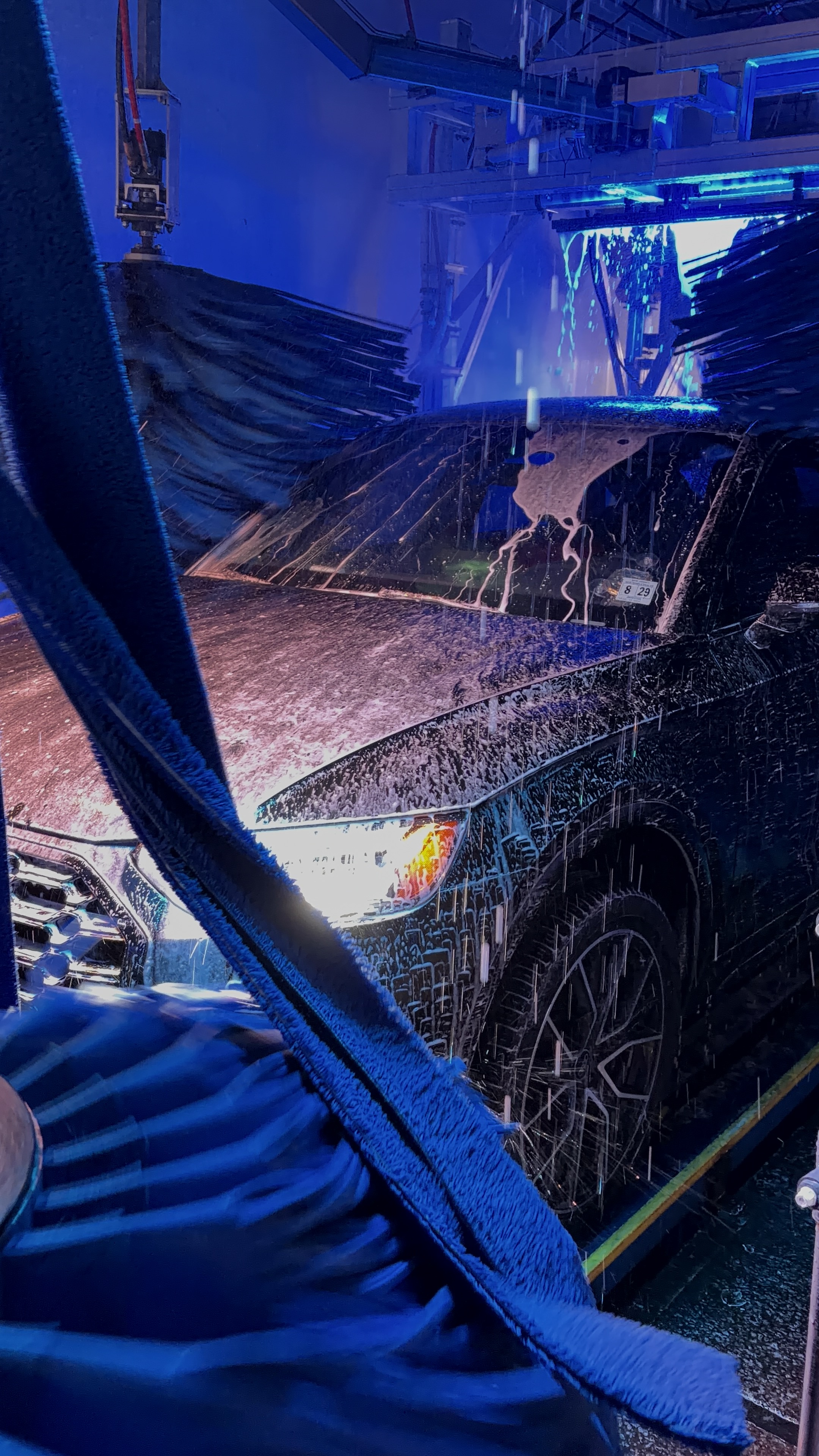 Car going through the wash with light hitting it