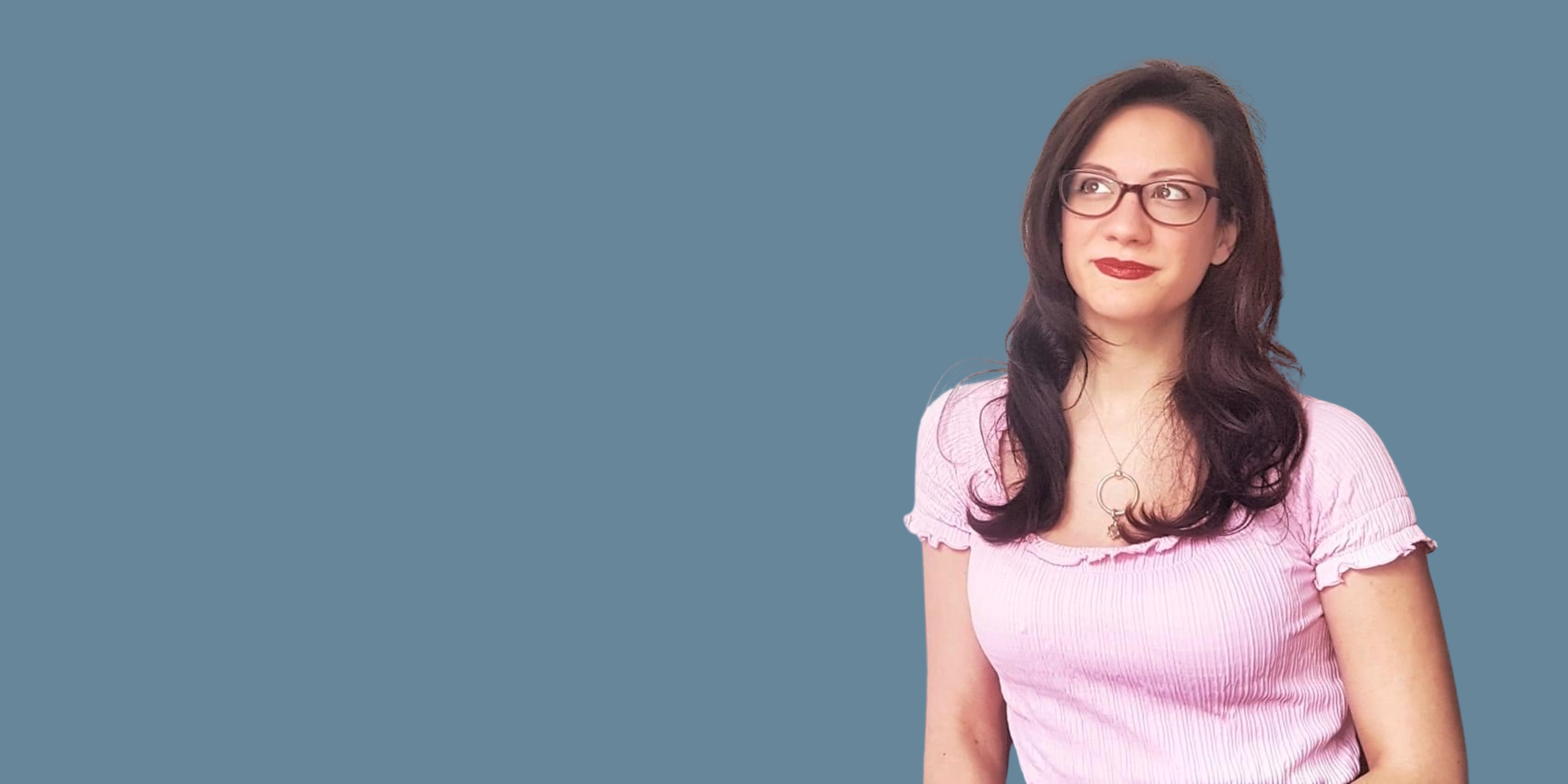 a lady looking up as if contemplating a decision such as having a photoshoot, with a slight grin on her face.