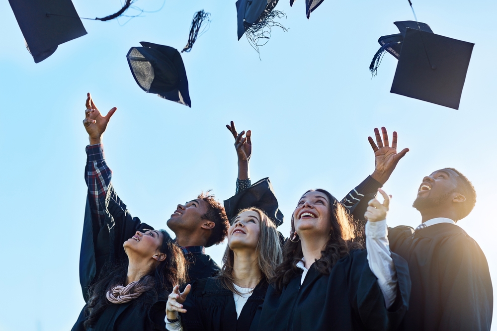 graduates throwing their cap