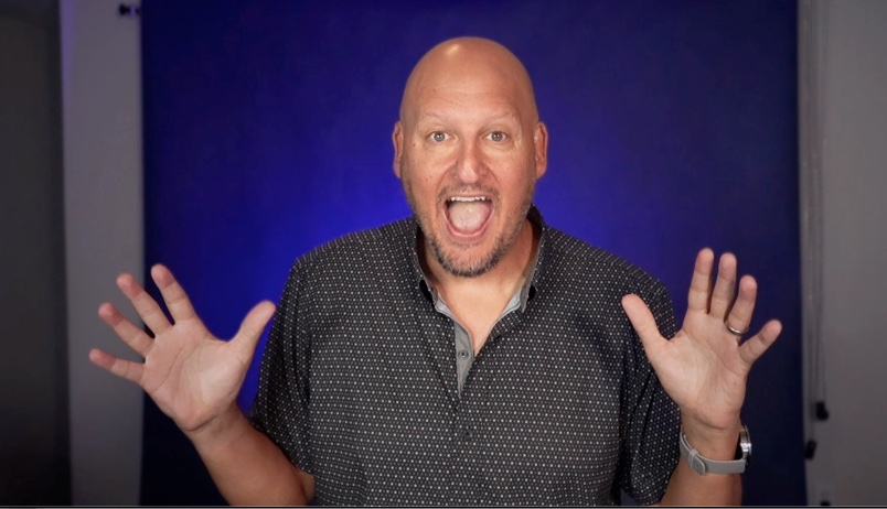 Todd Wall with both hands up, mid-laugh