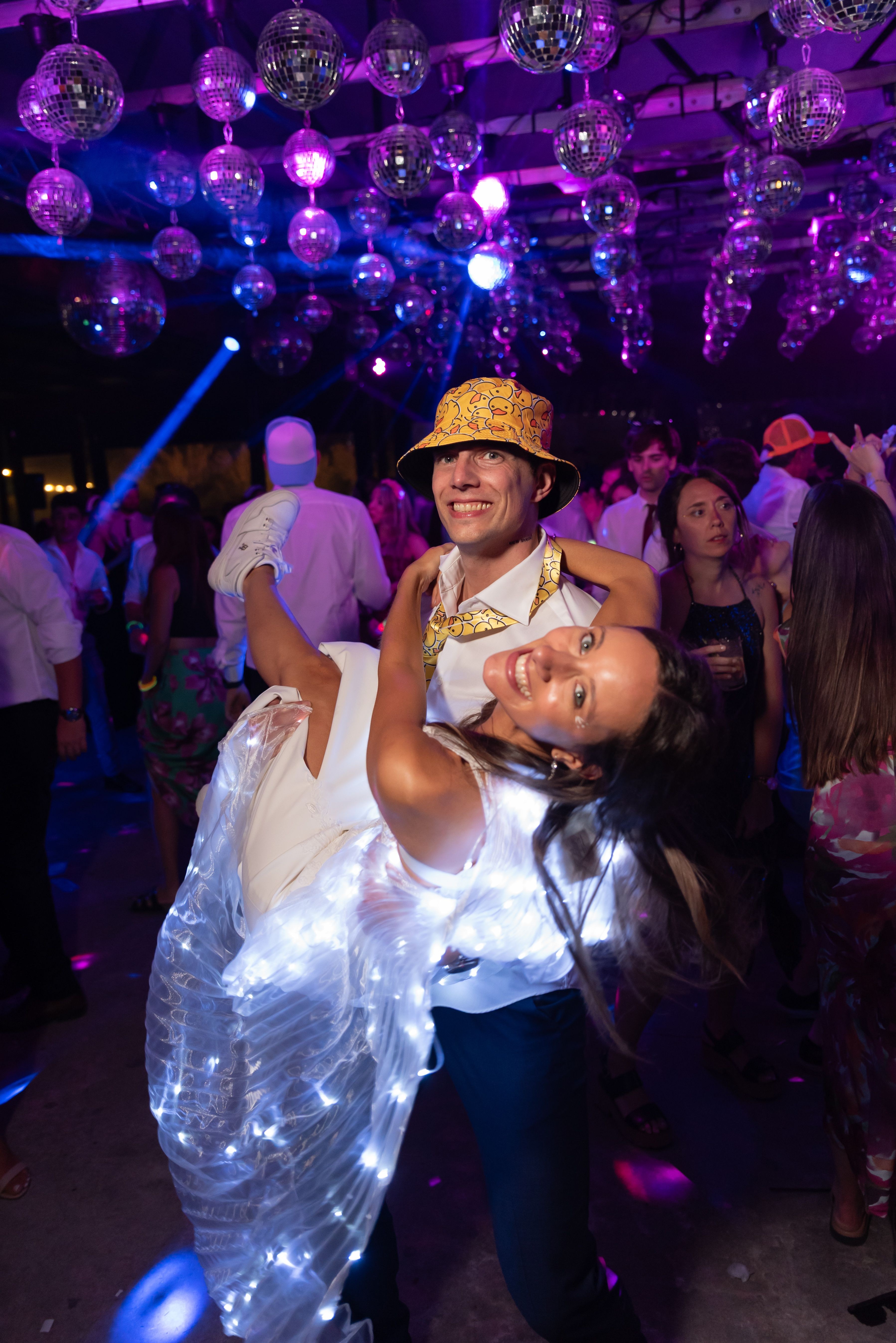 The Snapped magic mirror photo booth glowing at a party with a disco ball dancefloor in Cornwall