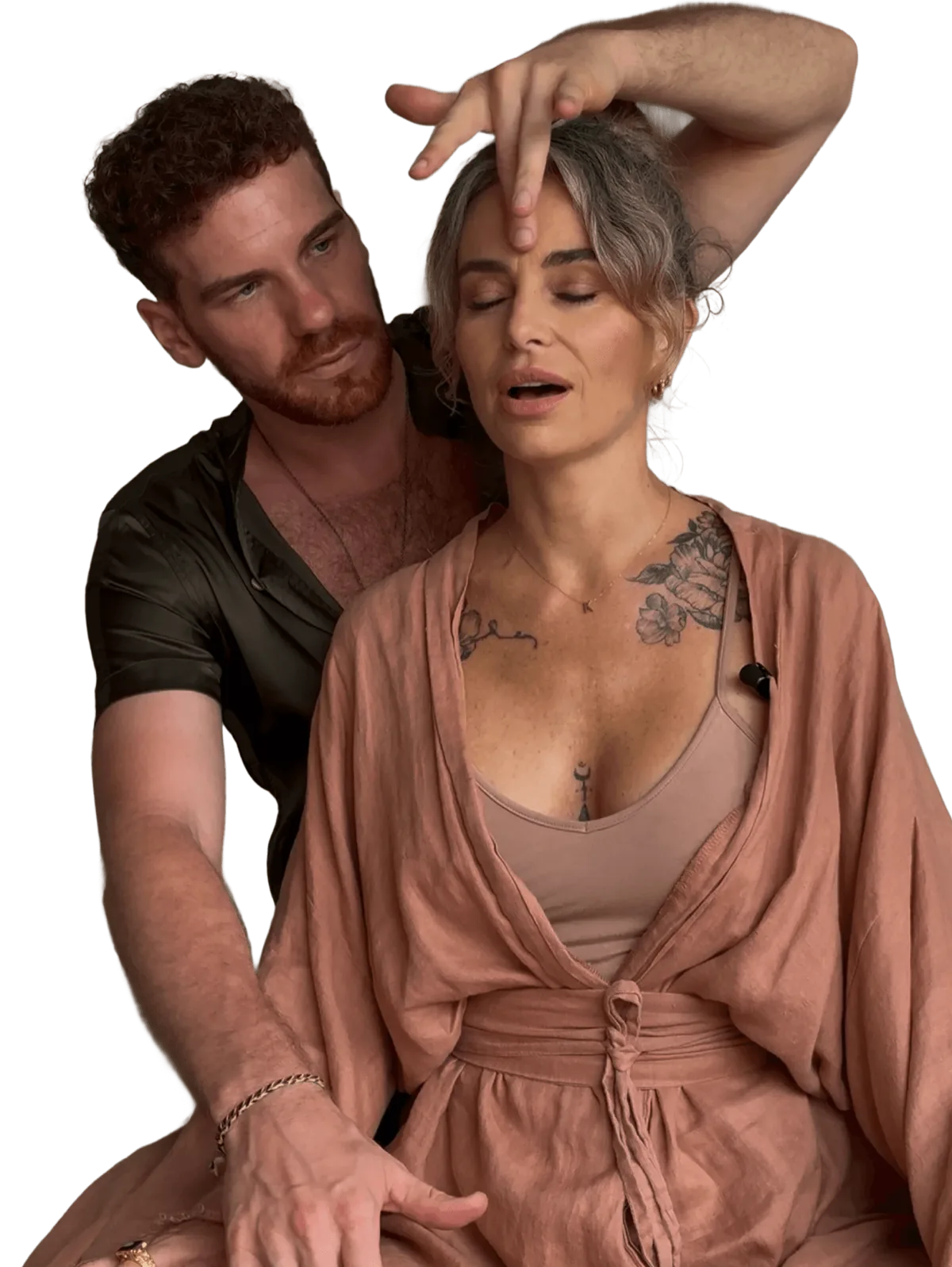 A Vādma practitioner supporting a client&rsquo;s head and neck during a group session