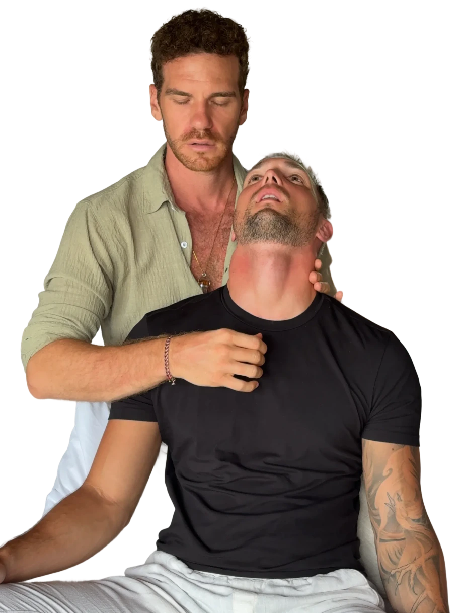 A Vādma practitioner supporting a client's neck and shoulders during a nervous system session