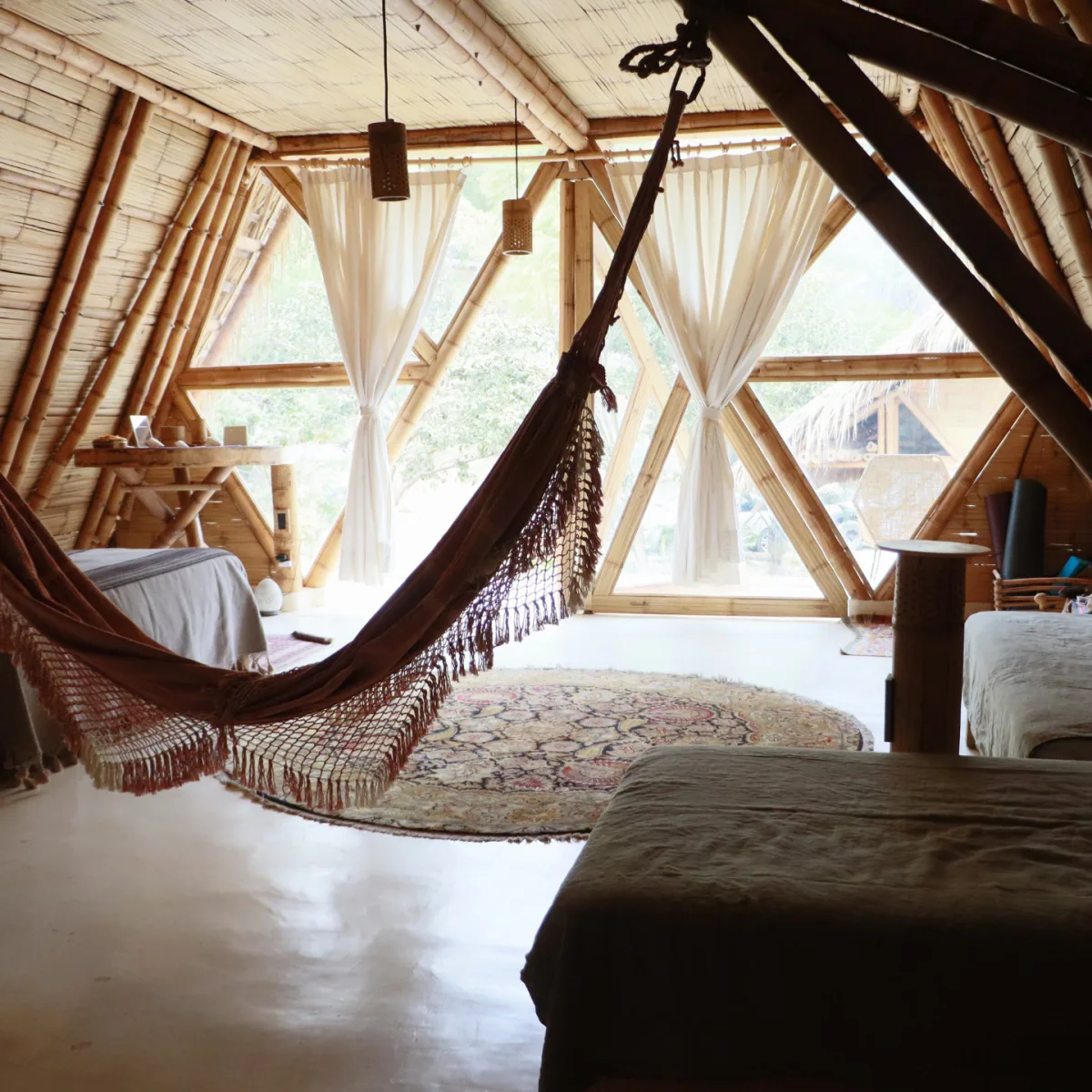 A bamboo dome bedroom with a hammock at the Vādma training accommodation in Mexico