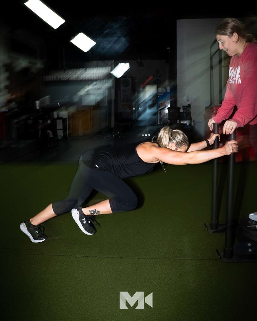 Coach and athlete inside Fame Strength gym