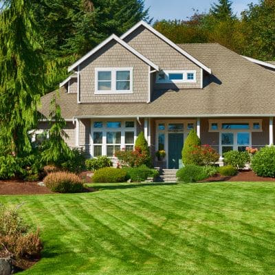 Front yard with neatly trimmed lawn and well-designed landscape.