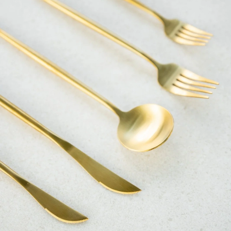 Gold cutlery set for elegant Bay of Islands wedding hire, perfect for formal receptions