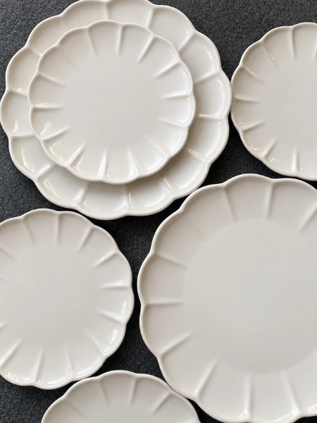 Cream Scalloped Side Plates over black background