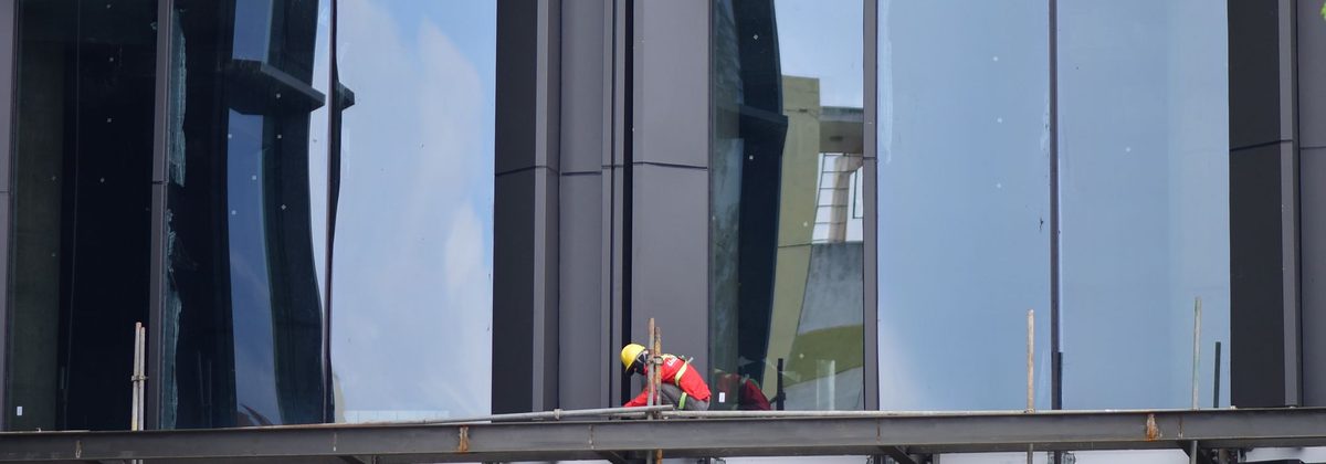 Glazing being installed on a commercial curtain-wall facade