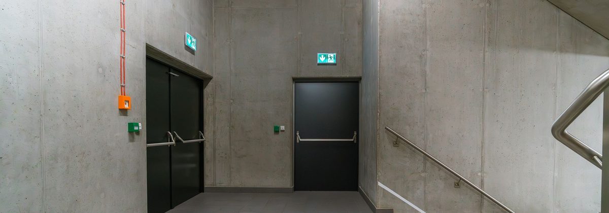 Steel exit doors with panic bars in a commercial stairwell