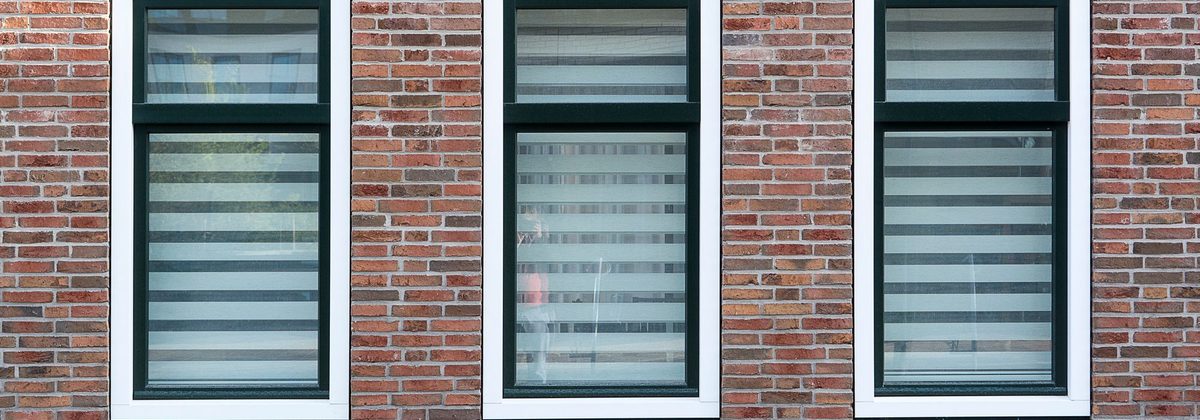 Brick wall with windows finished in clean white exterior trim