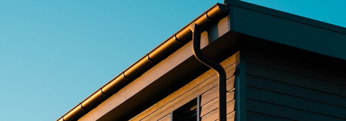 Eavestrough and downspout along a house roofline