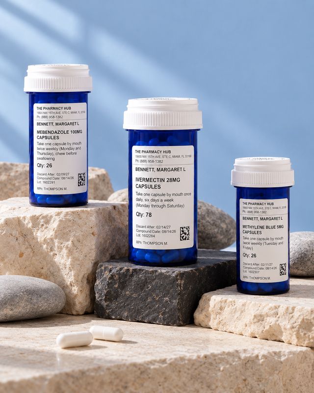 Three prescription bottles from The Pharmacy Hub, on stone