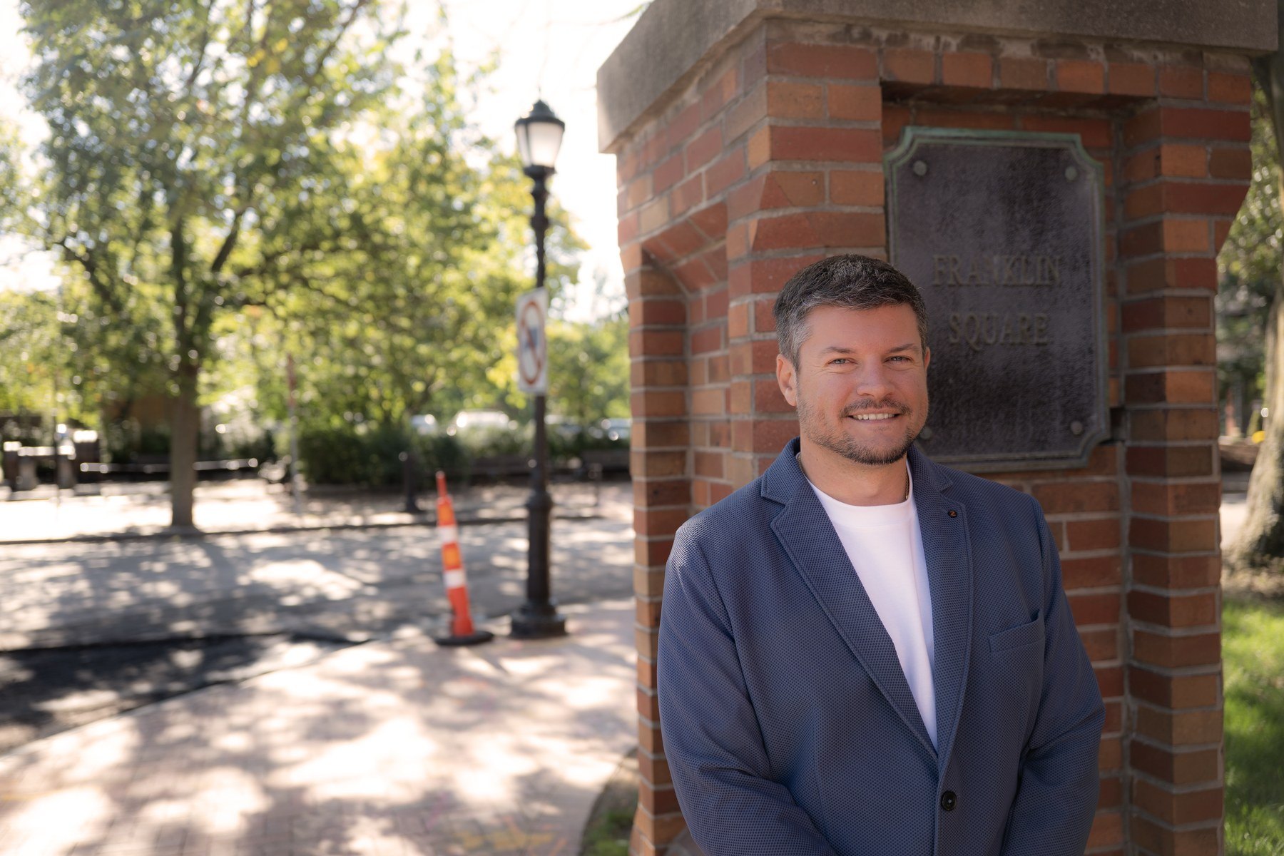 Brandon Camperlino on a tree-lined street in his district