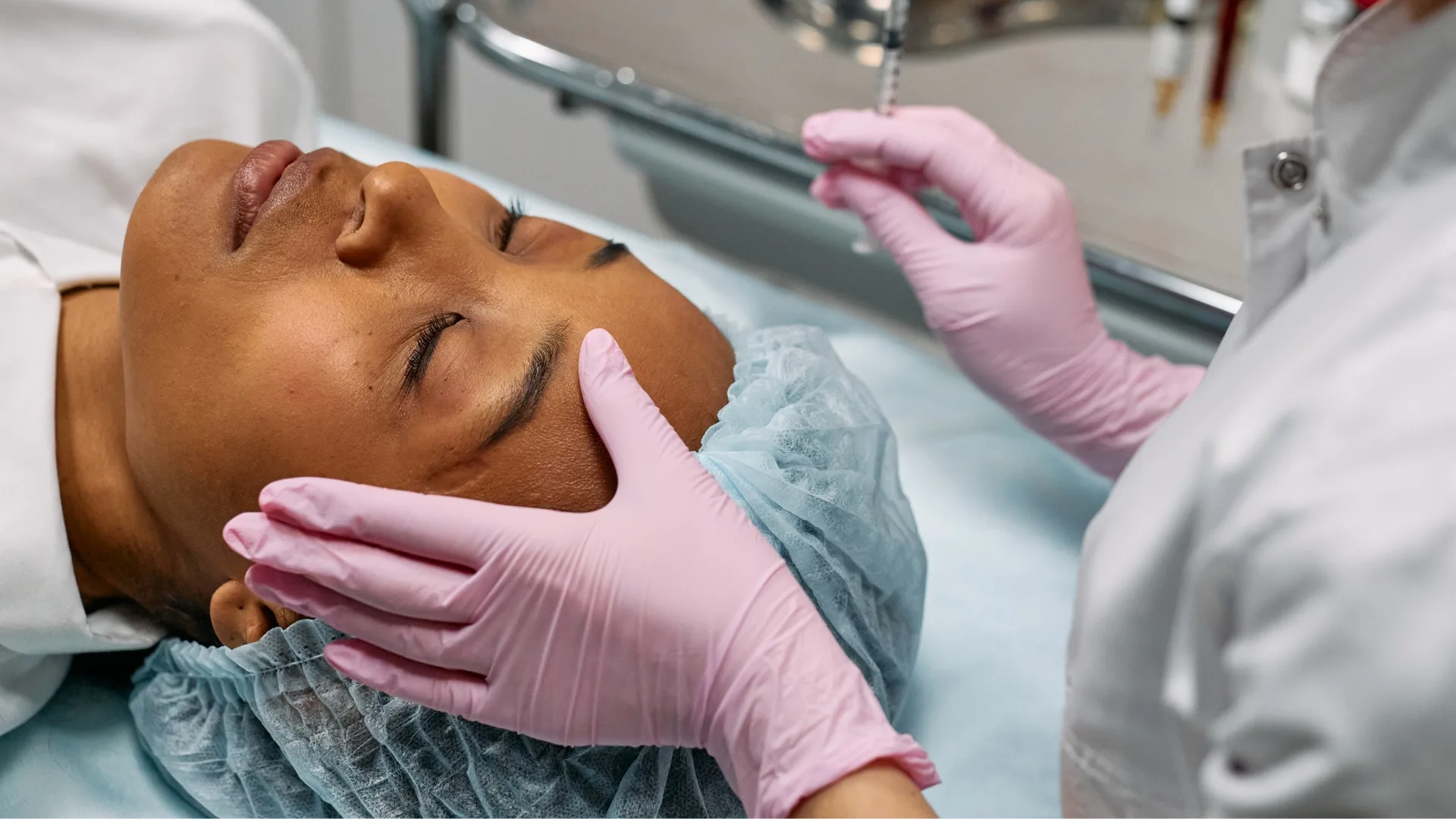 Gloved provider performing a skin treatment