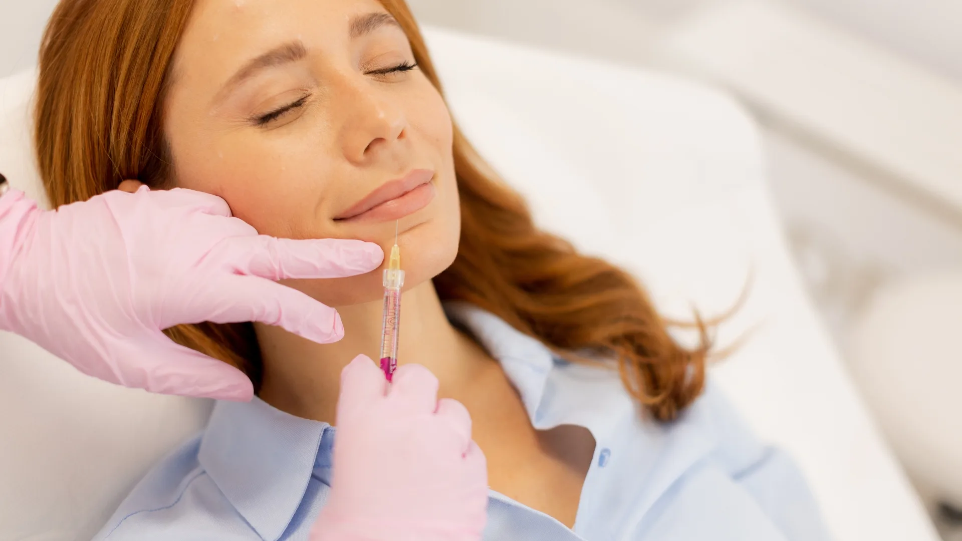 Lip filler treatment with a gloved provider