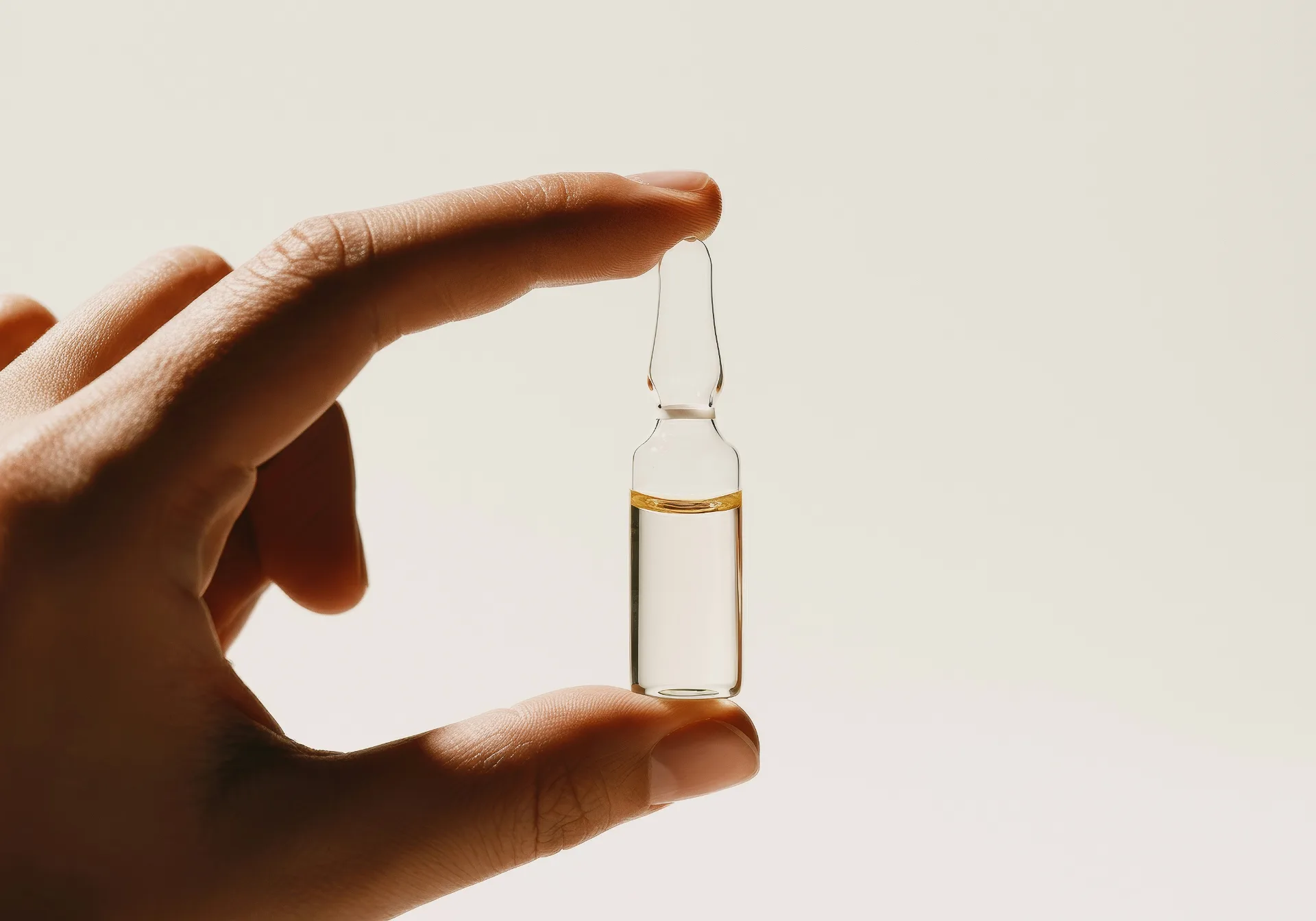 Small vial of glutathione held between two fingers