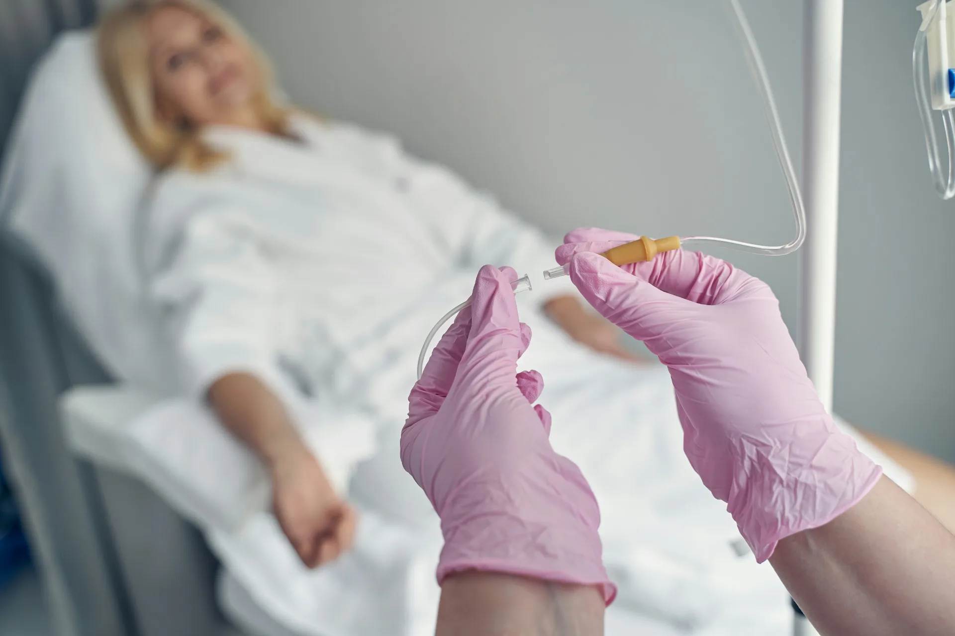 IV line being set up for a client resting in a robe