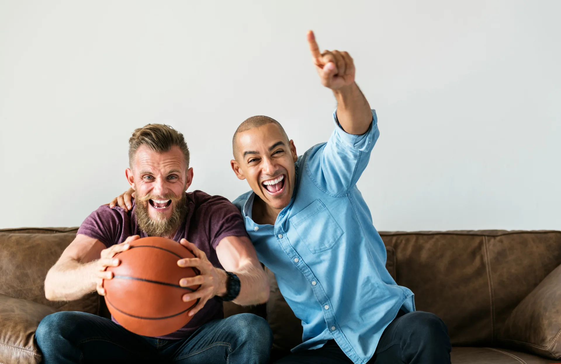 Two men cheering while watching the game