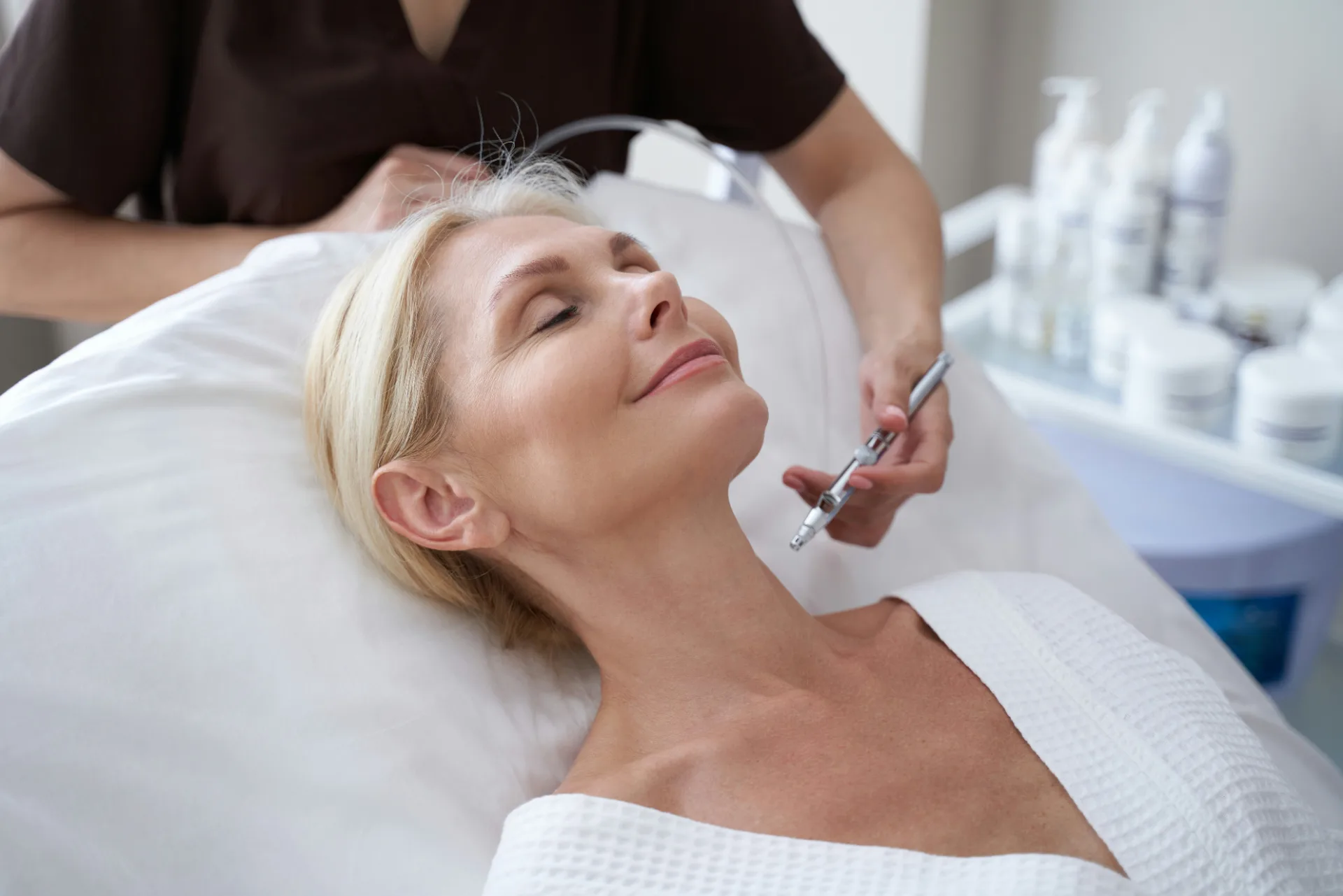 Woman relaxing with her eyes closed during a skin treatment