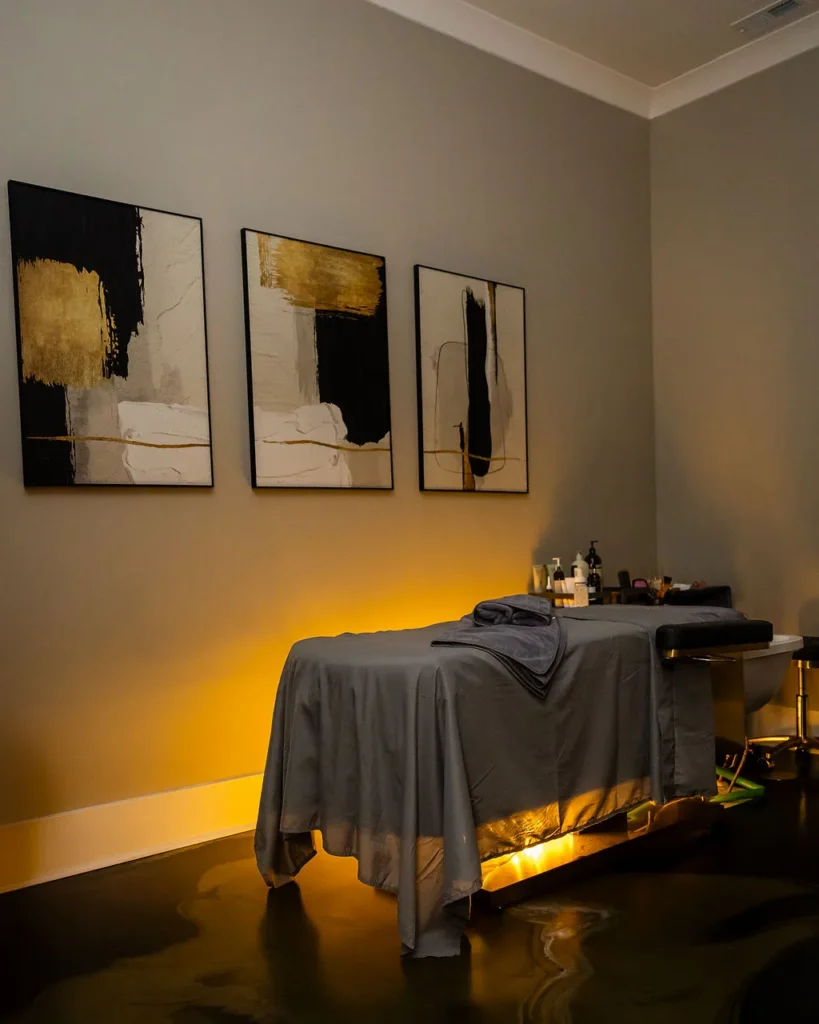 Treatment room at Lexel with a heated table, warm lighting and framed artwork