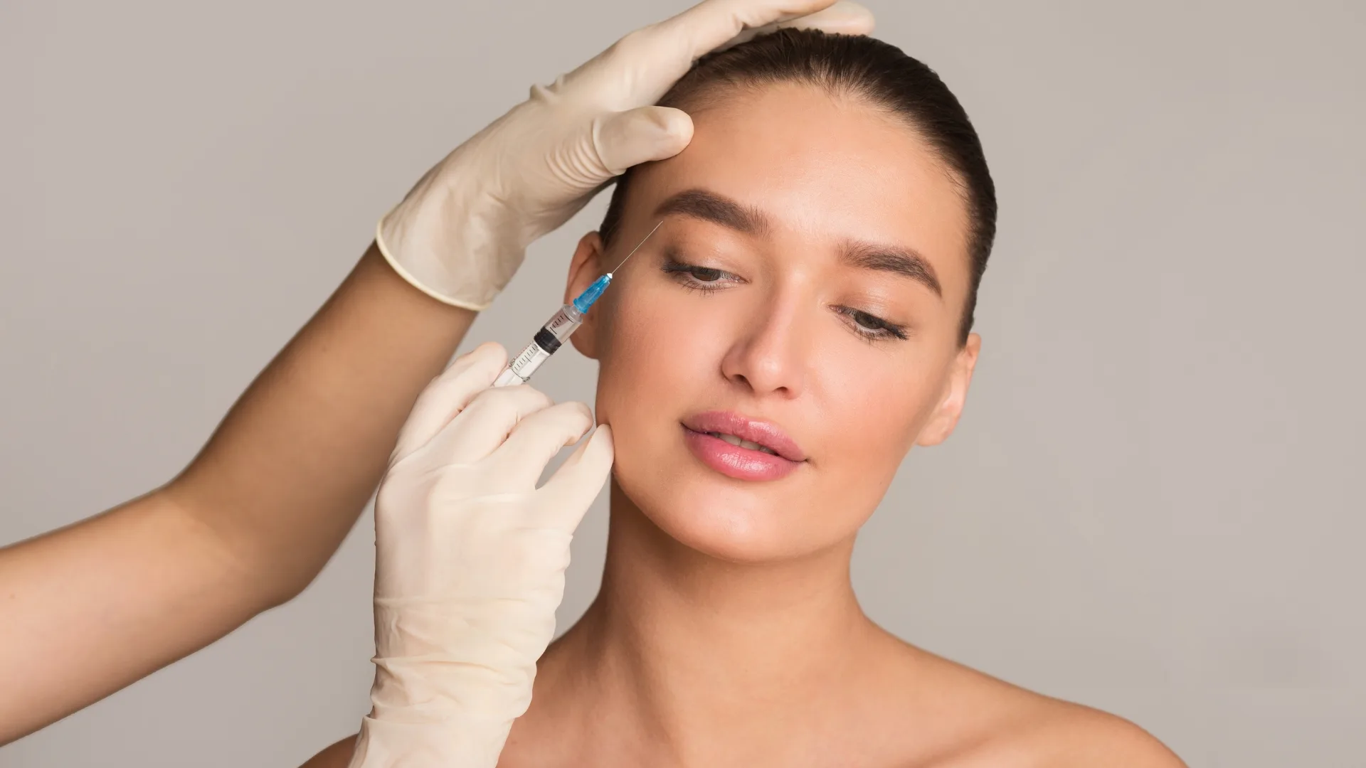 Provider administering a wrinkle relaxer injection to the forehead