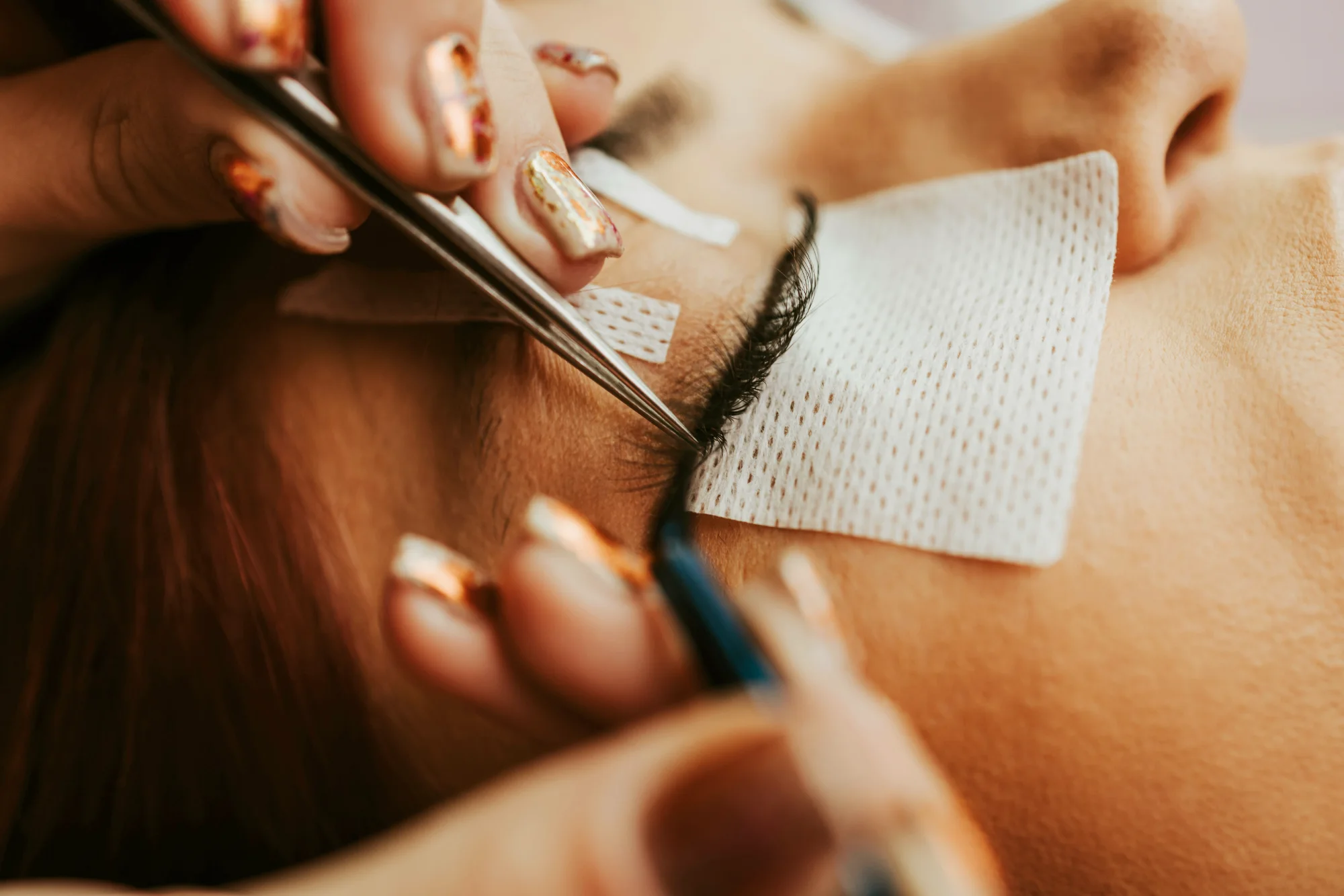 Eyelash extensions being applied with under-eye patches in place