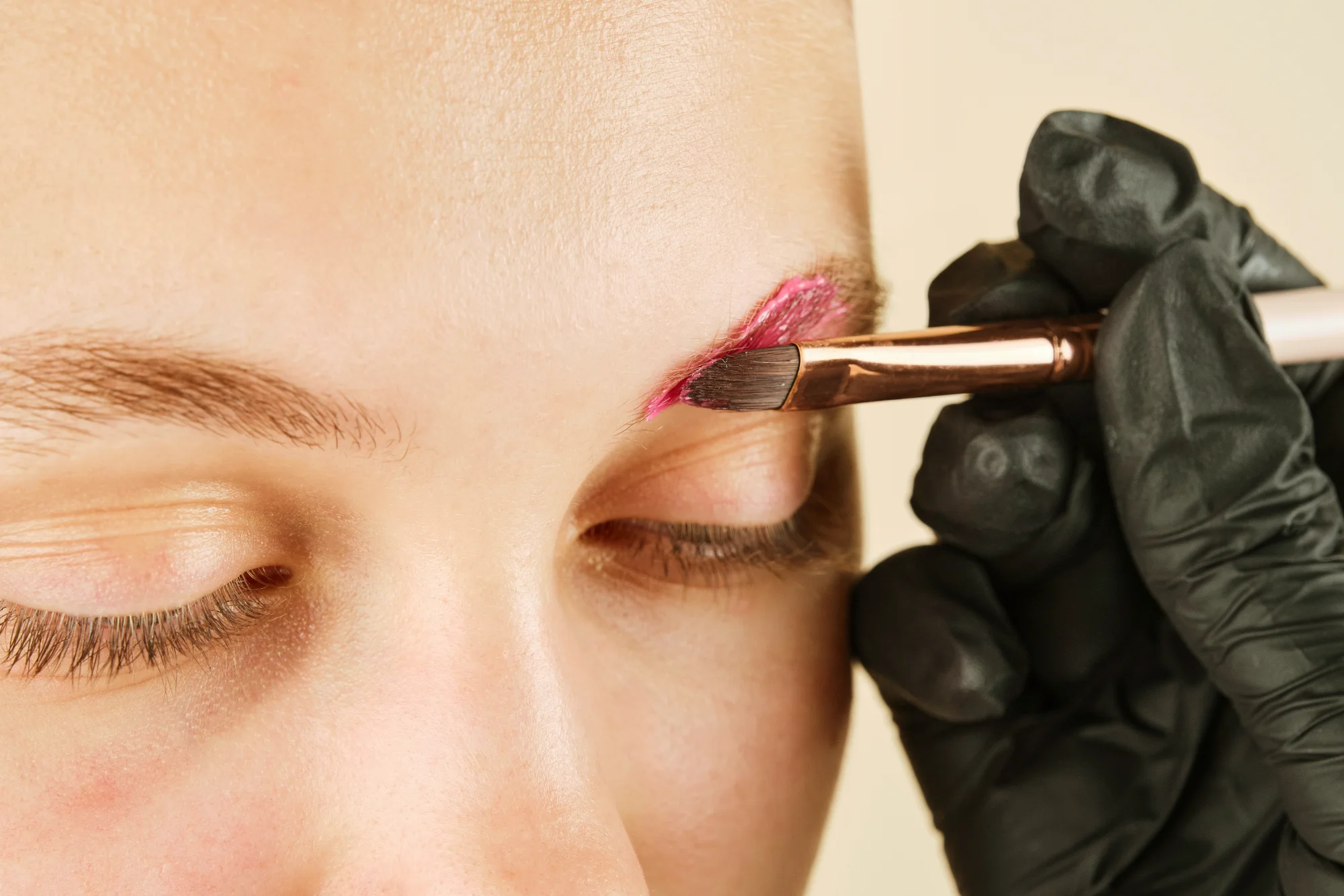 Brow tint being applied with an angled brush
