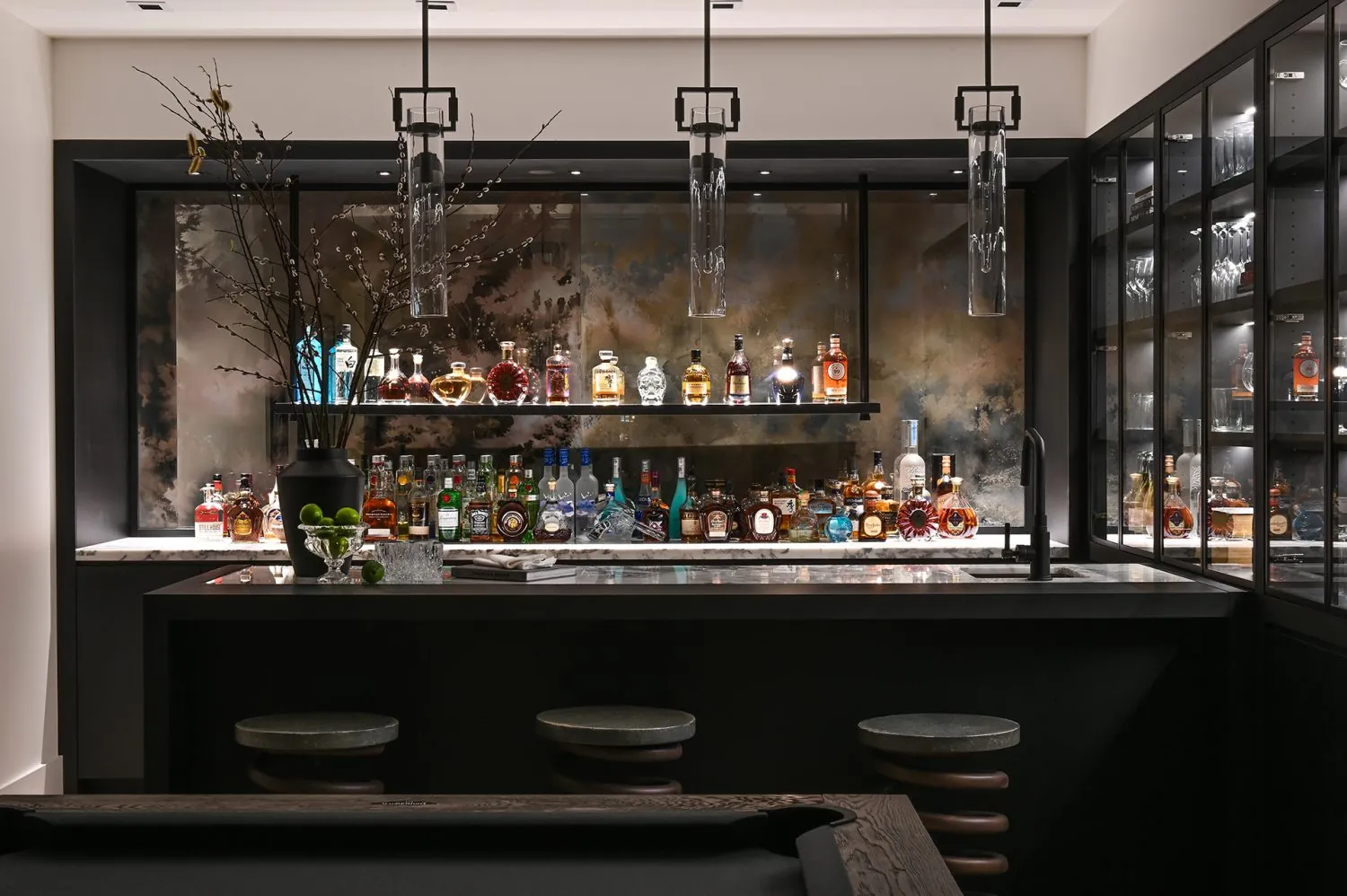 Basement bar with dark cabinet painting in the Ferme Moderne custom home