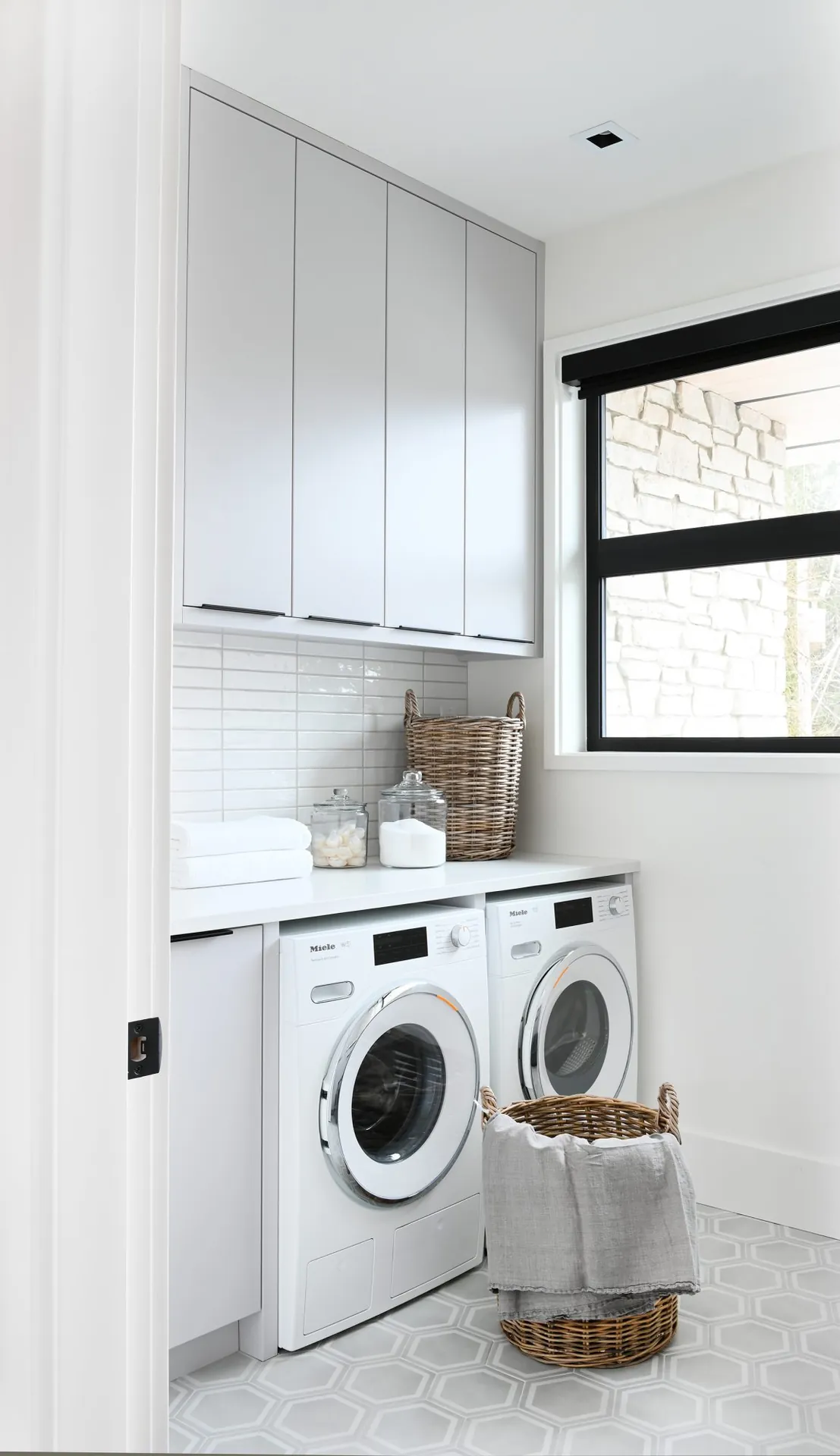 Laundry room cabinet painting in the Ferme Moderne custom home