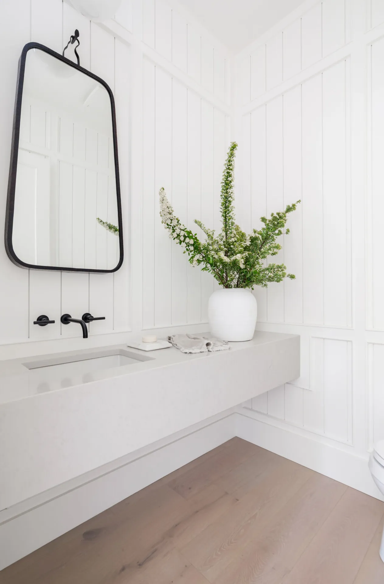 Powder room panelled wall painting in the Glover custom home