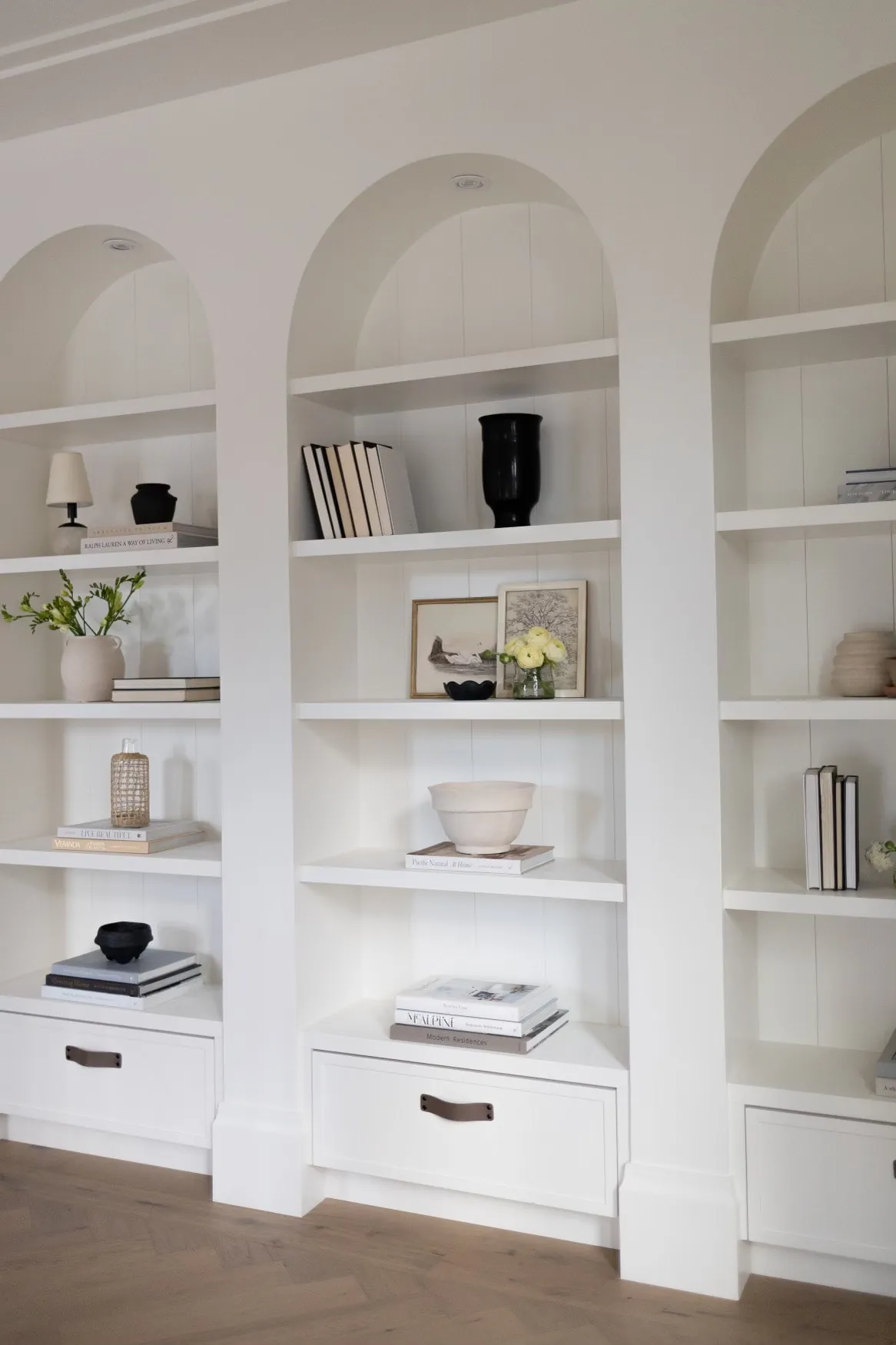 Arched built-in shelving painting in the Grove custom home
