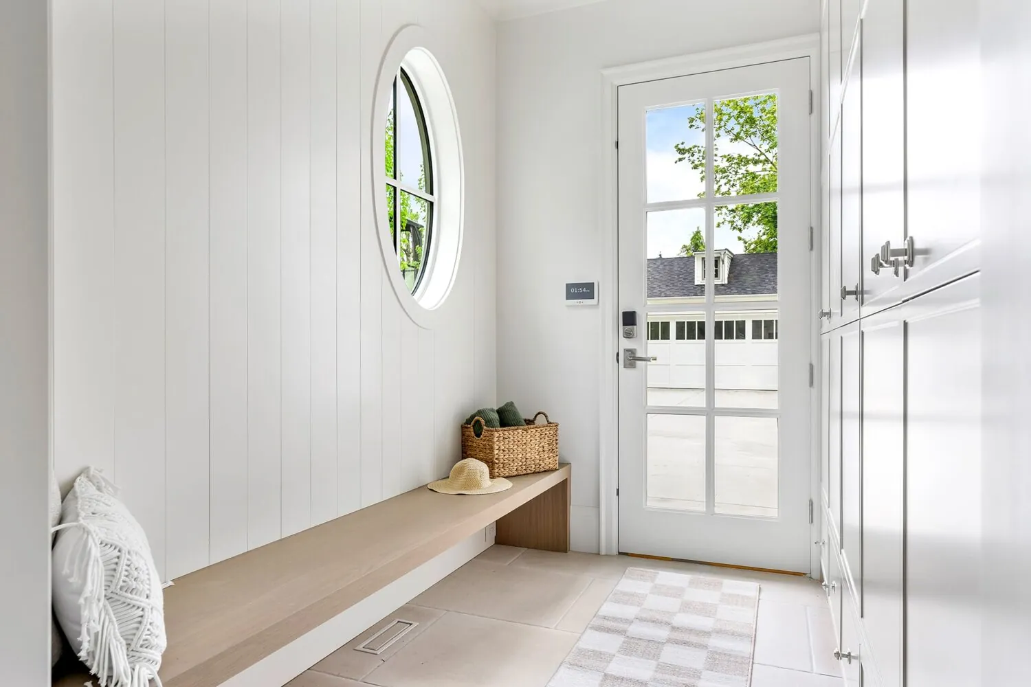 Mudroom entry with white panelled walls in the Jeffrey custom home