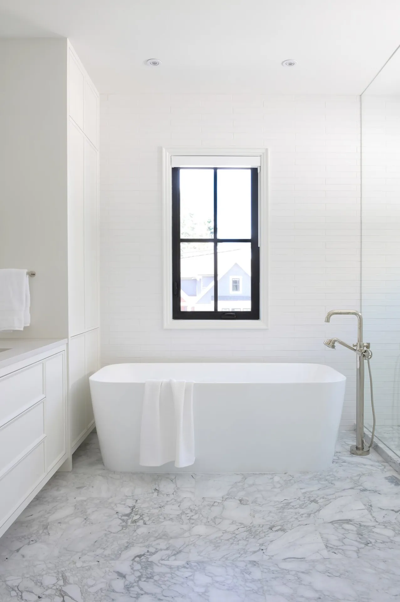 Ensuite with freestanding tub, bathroom painting in the Noir custom home