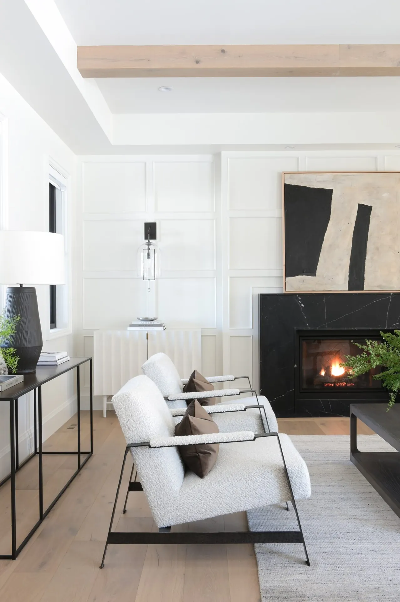Living room with black fireplace, interior painting in the Noir custom home