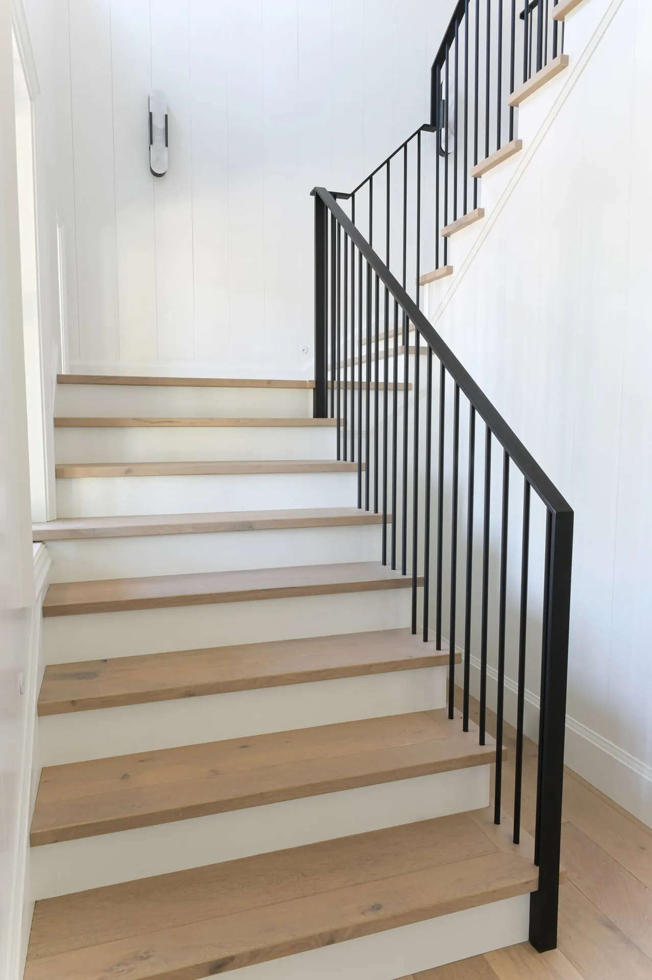 White staircase interior painting in the Noir custom home
