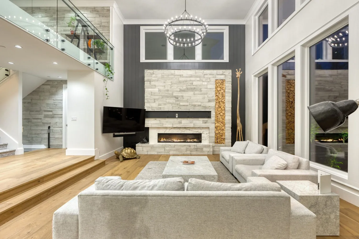 Two-storey living room with fireplace, interior painting in the Palm custom home