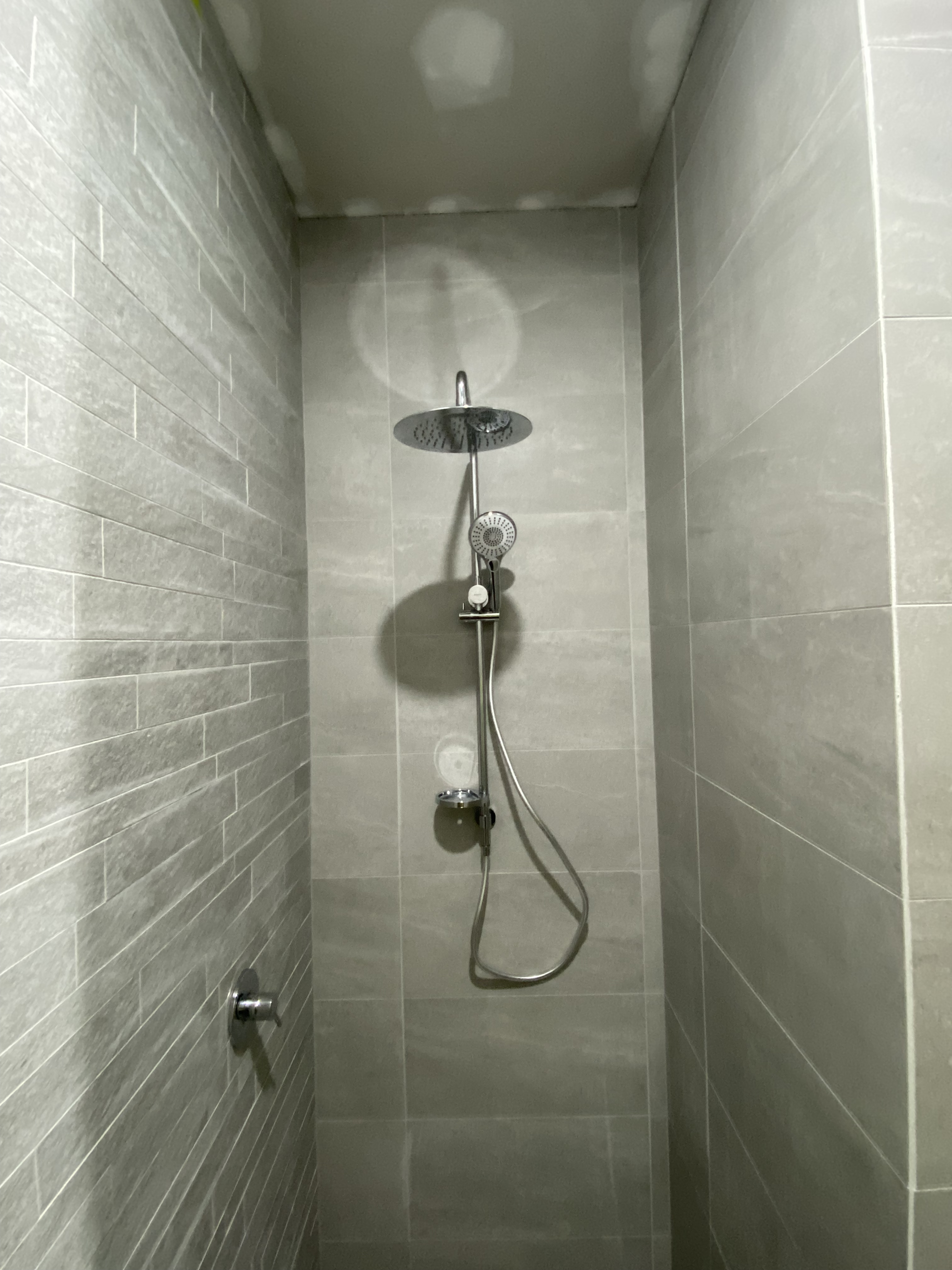 Compact Grey Tile Bathroom Upgrade photo 1