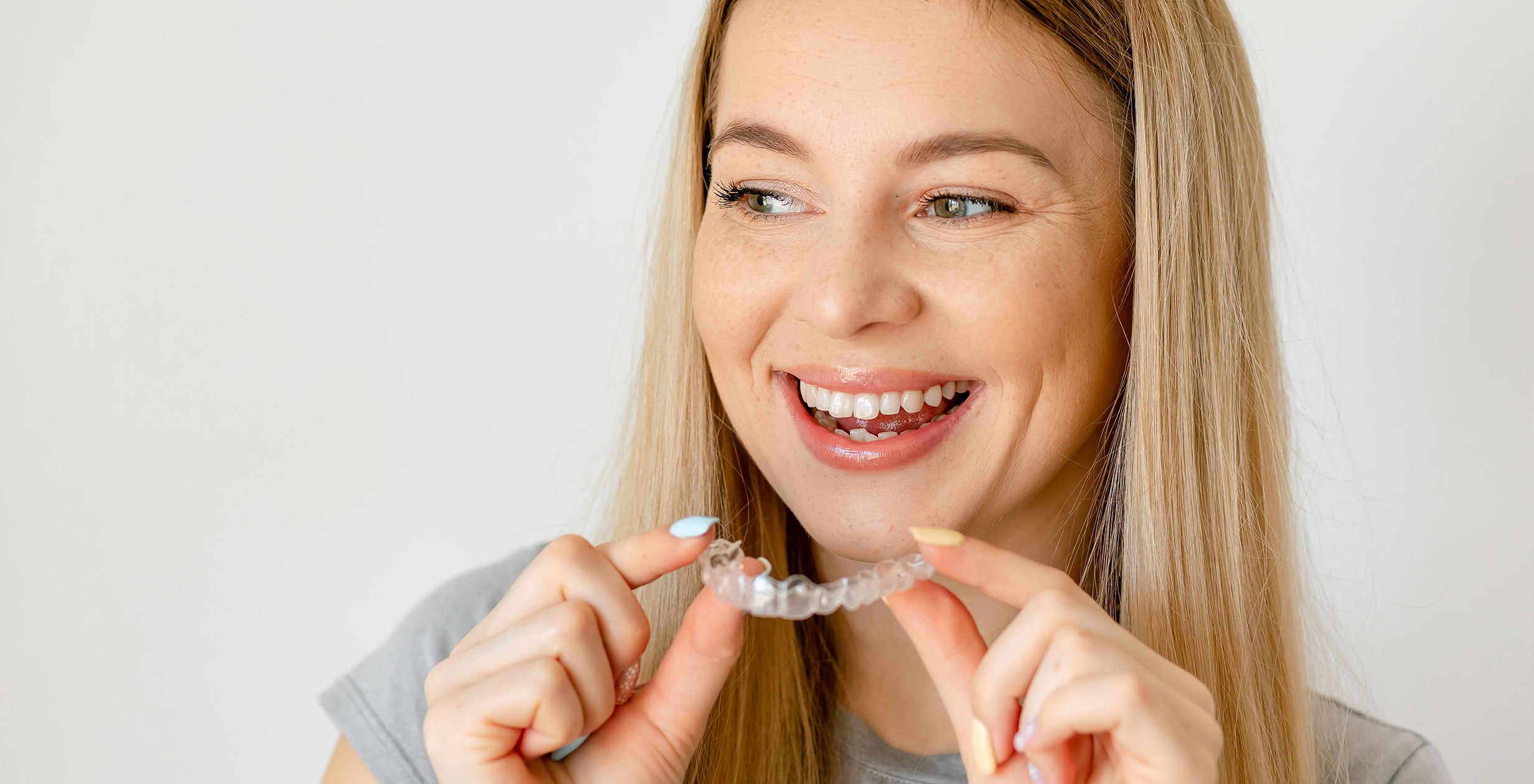 Woman holding invisalign