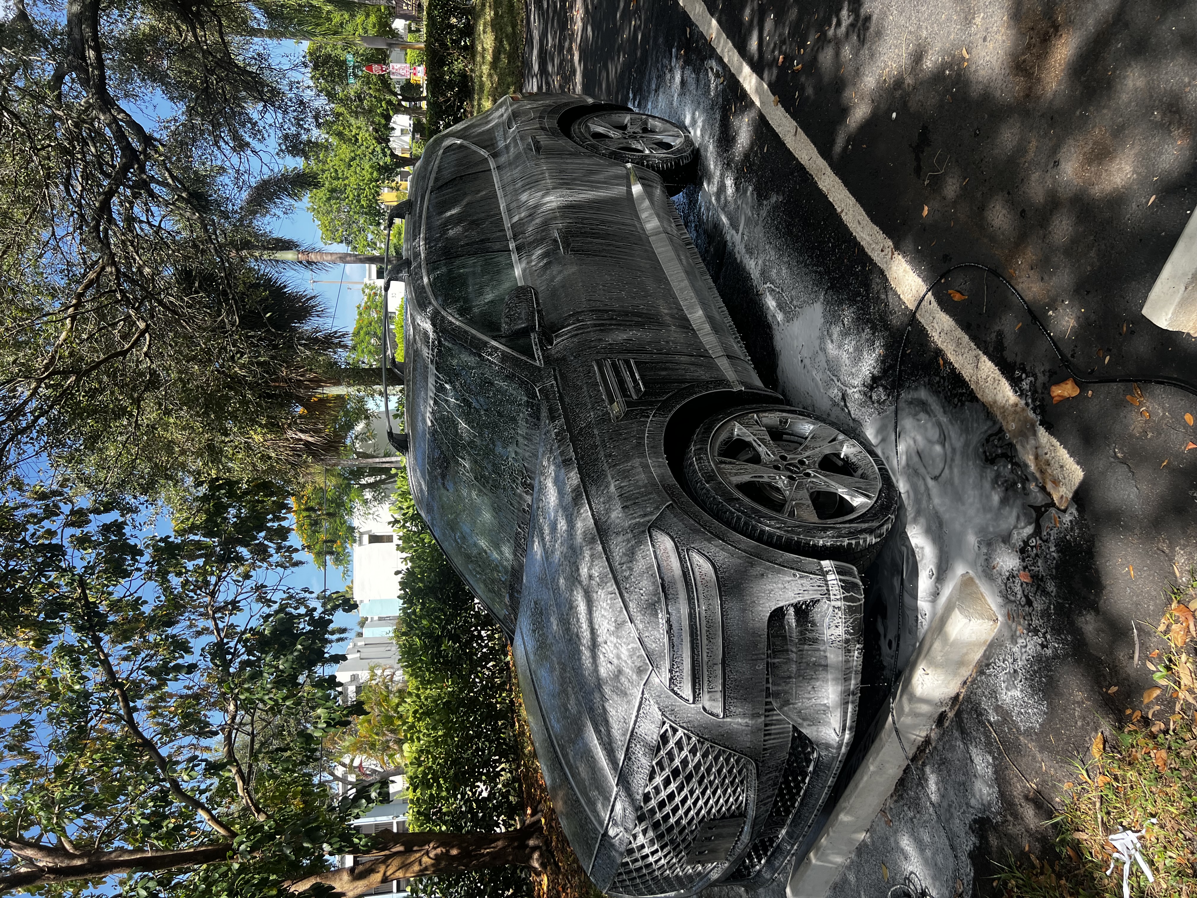 Close-up of a polished luxury car exterior with a deep, glossy finish after exterior detailing