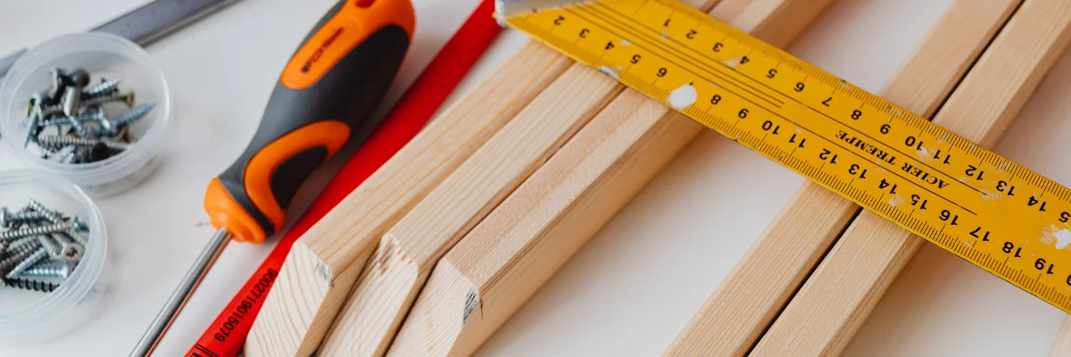 Carpentry tools with measuring tape, screwdriver, and wooden boards. Carpentry tools with measuring tape, screwdriver, and wooden boards.