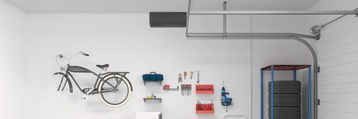Organized garage wall with bicycle, tools, and storage rack. Organized garage wall with bicycle, tools, and storage rack.