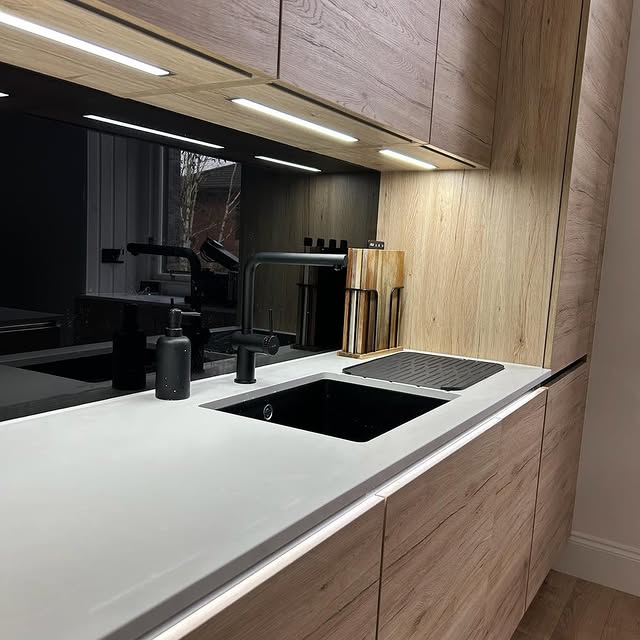 Dark fitted kitchen with timber cabinetry completed by Core Joinery and Interiors