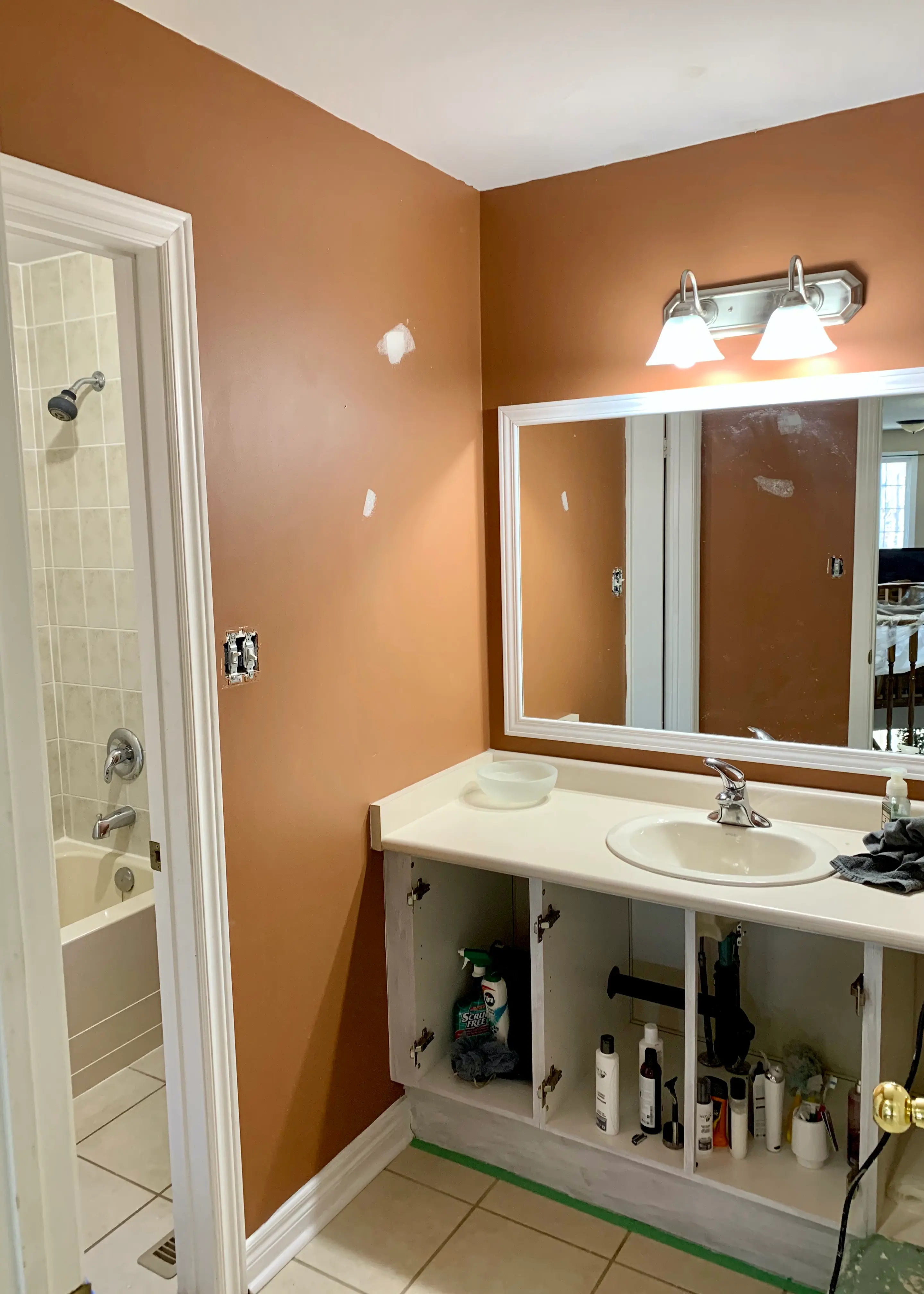 Bathroom before paint colour consultation — outdated orange walls in Durham Region home