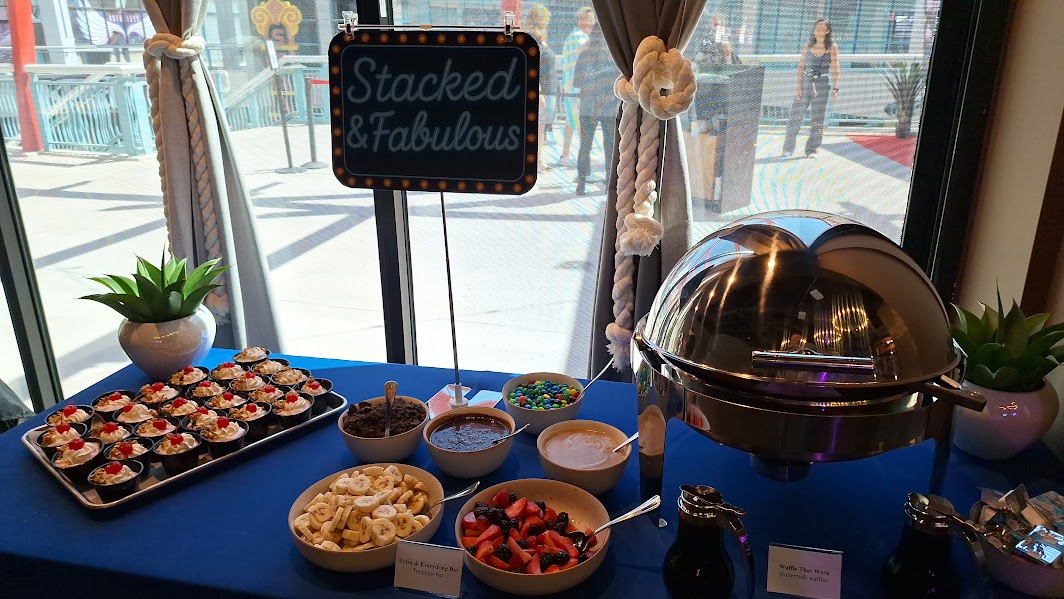 All-you-can-enjoy brunch buffet spread featuring pastries, fresh fruit, savory dishes, with bottomless mimosas in champagne flutes.