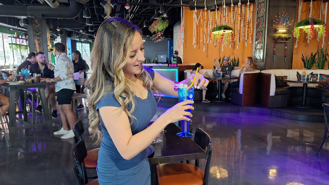 Server preparing a signature cocktail at Viva Drag Brunch Las Vegas.